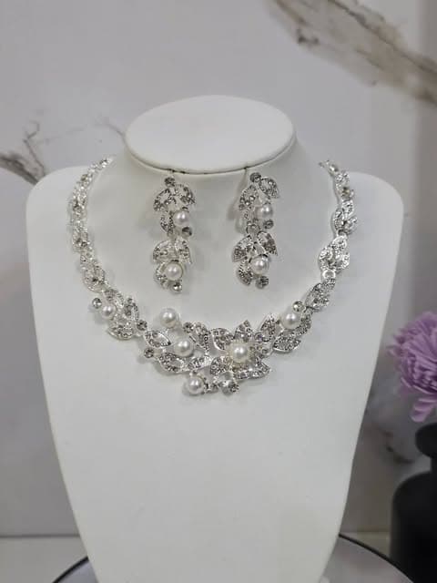 Fredelle’s silver-tone floral necklace and matching earrings with white bead accents